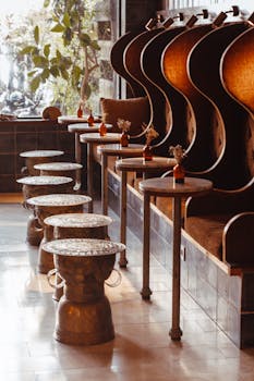 Beautifully designed coffee shop interior featuring eclectic seating, warm tones, and vintage tables.