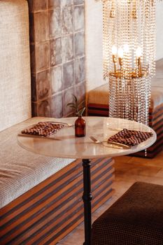 Chic dining table setup with modern decor and warm lighting for a cozy ambiance.