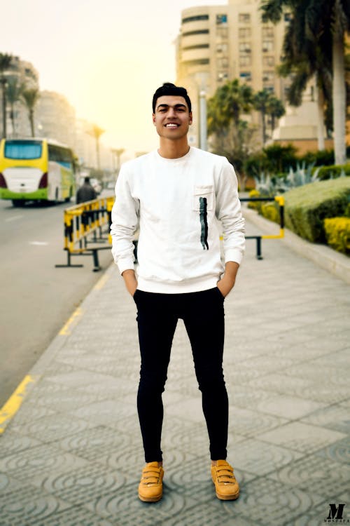 Free Man in White Crew-neck Sweater Taking Selfie Beside Street Road Stock Photo