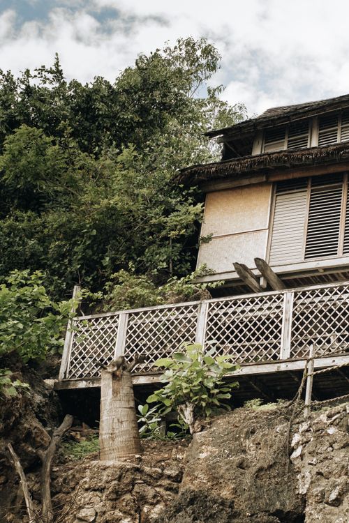 Free A vintage wooden house surrounded by dense greenery, showcasing rustic charm and natural beauty. Stock Photo