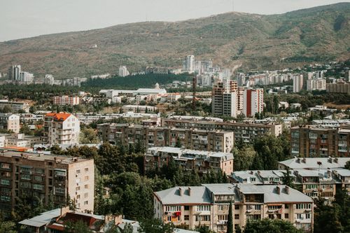 Free Aerial view of Tbilisi showing urban landscape with mountains in the background. Stock Photo