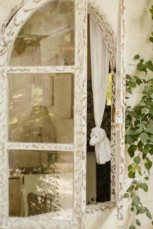 An Open Window with White Curtain