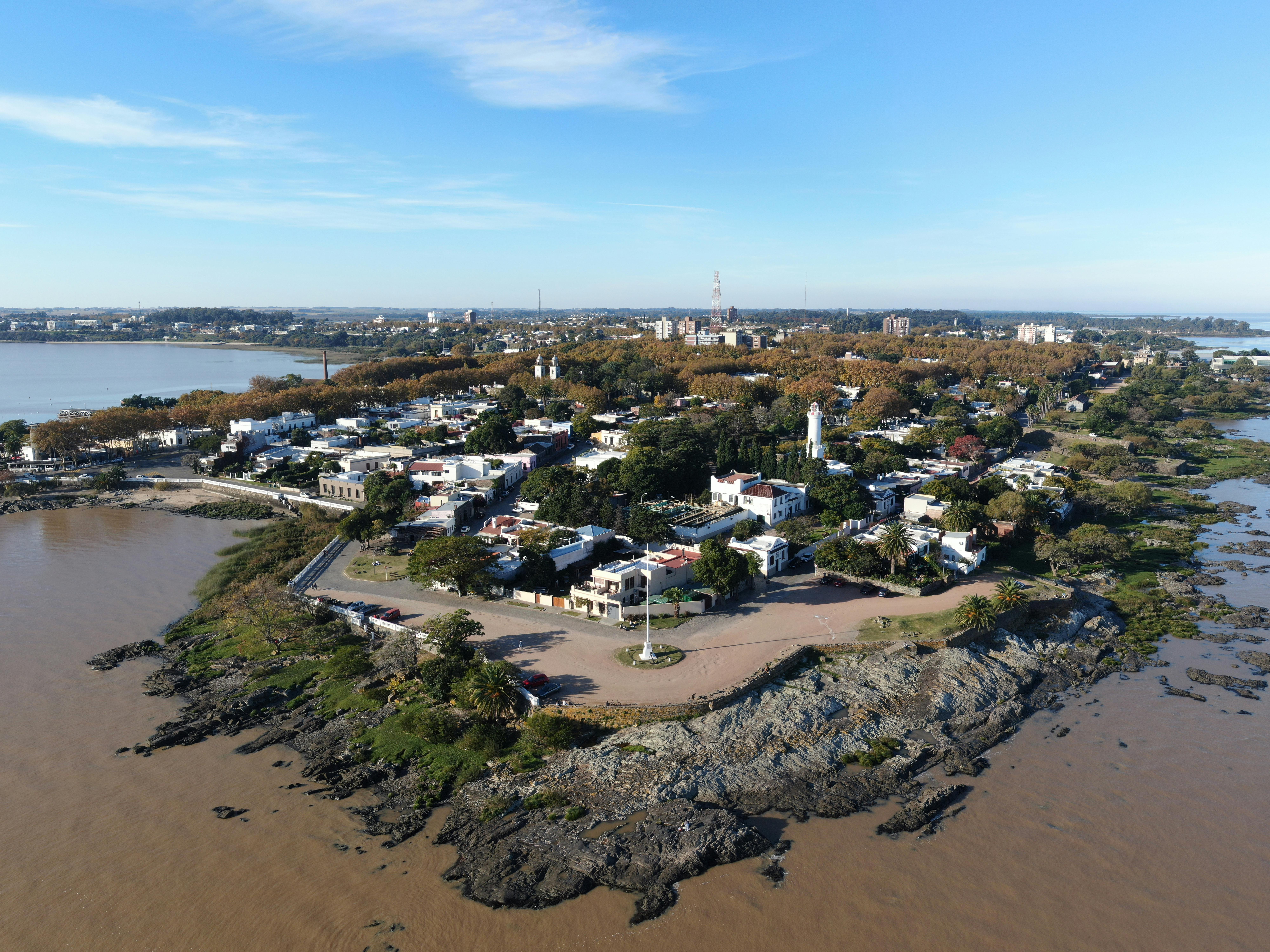 A scenic aerial view of Colonia Del Sacramento's coastline capturing its historical charm and natural beauty.