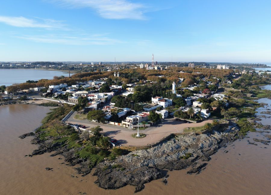 A scenic aerial view of Colonia Del Sacramento's coastline capturing its historical charm and natural beauty.