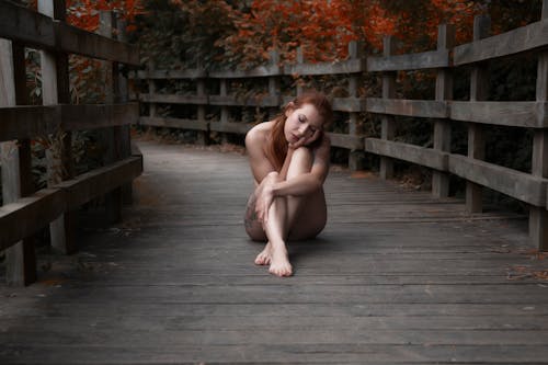 Naked Woman Sitting on Wooden Floor