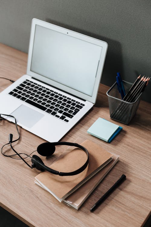 Notebook on the wooden desk · Free Stock Photo