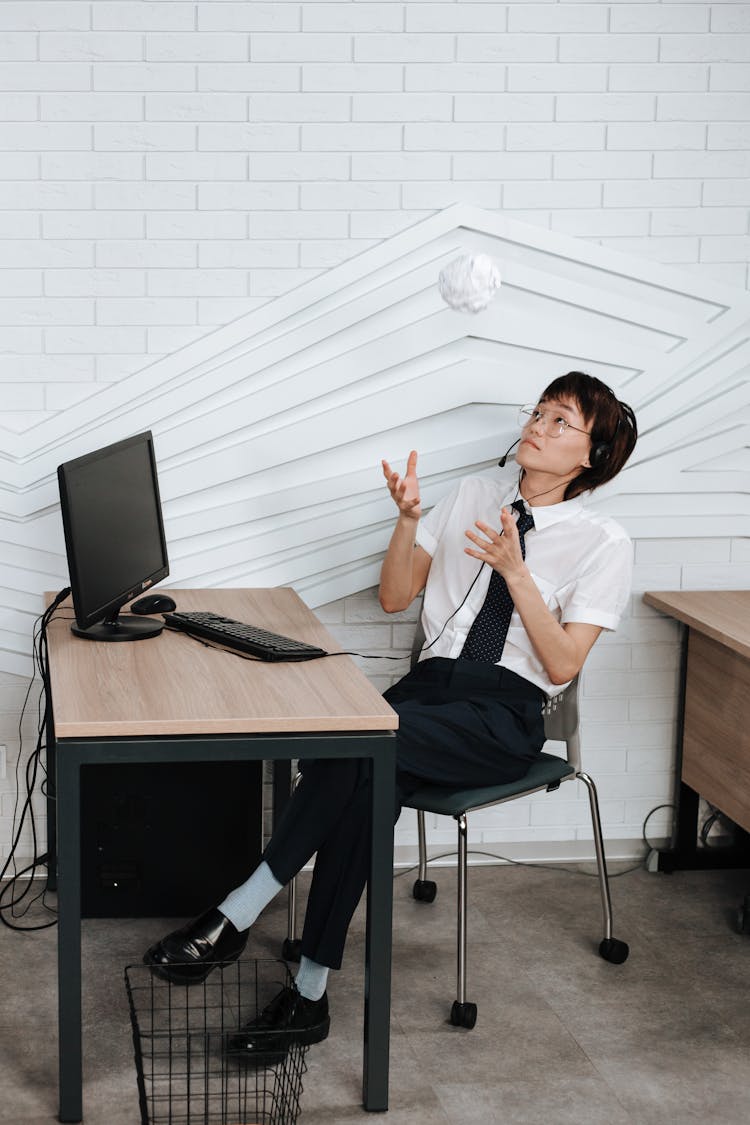 A Man Wearing Headset In Front Of A Computer