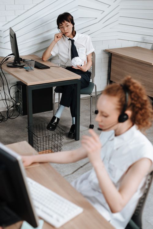Free Business colleagues collaborating in a call center. Diverse team wearing headsets focused at work. Stock Photo