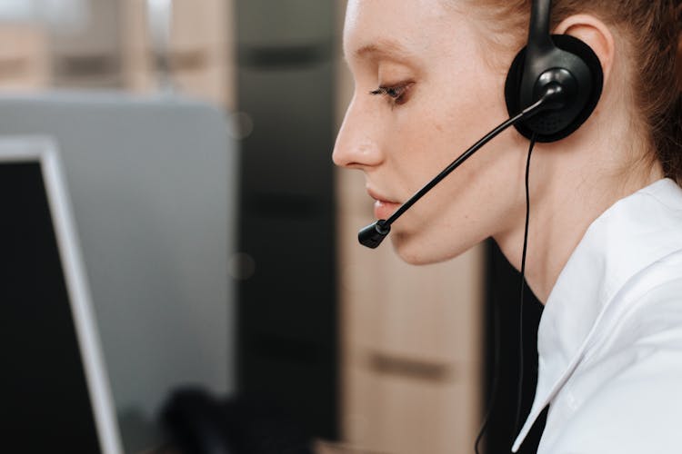 Side View Of A Woman Wearing Headset