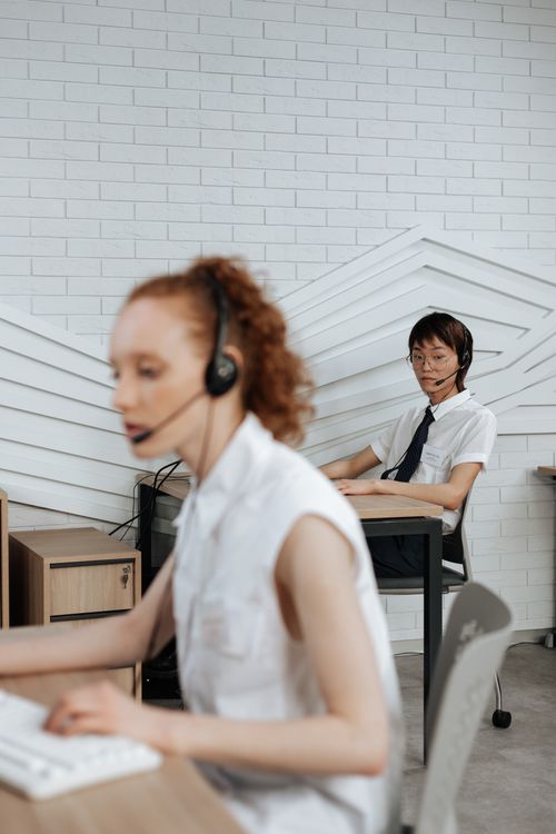 Free Focused customer service representatives working in a modern office space. Stock Photo
