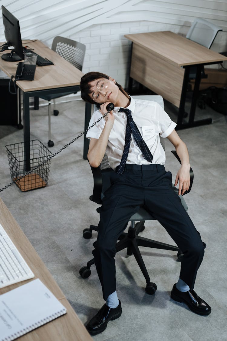 Tired Worker Talking On The Telephone Inside A Office