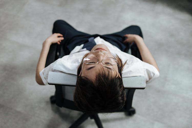 Man Reclining In An Armchair Feeling Exhausted