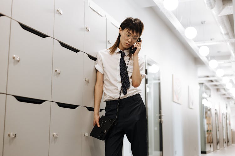 A Man With A Necktie Talking On The Telephone