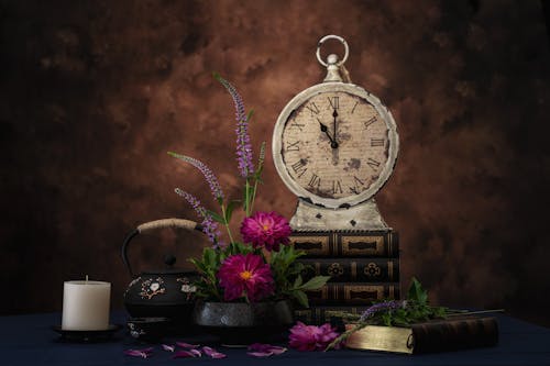 An Old Clock and Flowers on a Table