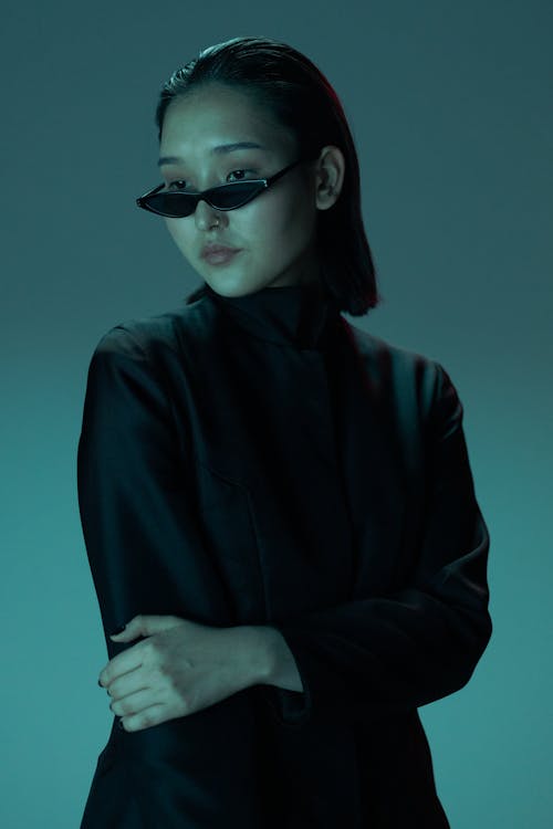 Free A Woman in Black Long Sleeves Wearing Sunglasses Stock Photo