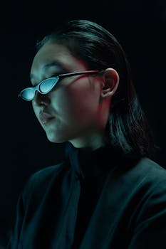 Futuristic portrait of an Asian woman in cyberpunk style with sleek sunglasses.