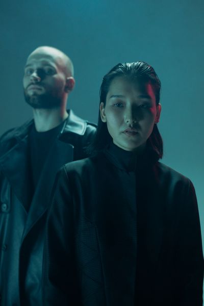 Duo in dark coats under blue studio light — cottonbro studio on Pexels