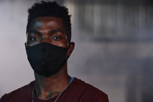 Photo of a Man Wearing a Black Face Mask Looking at the Camera