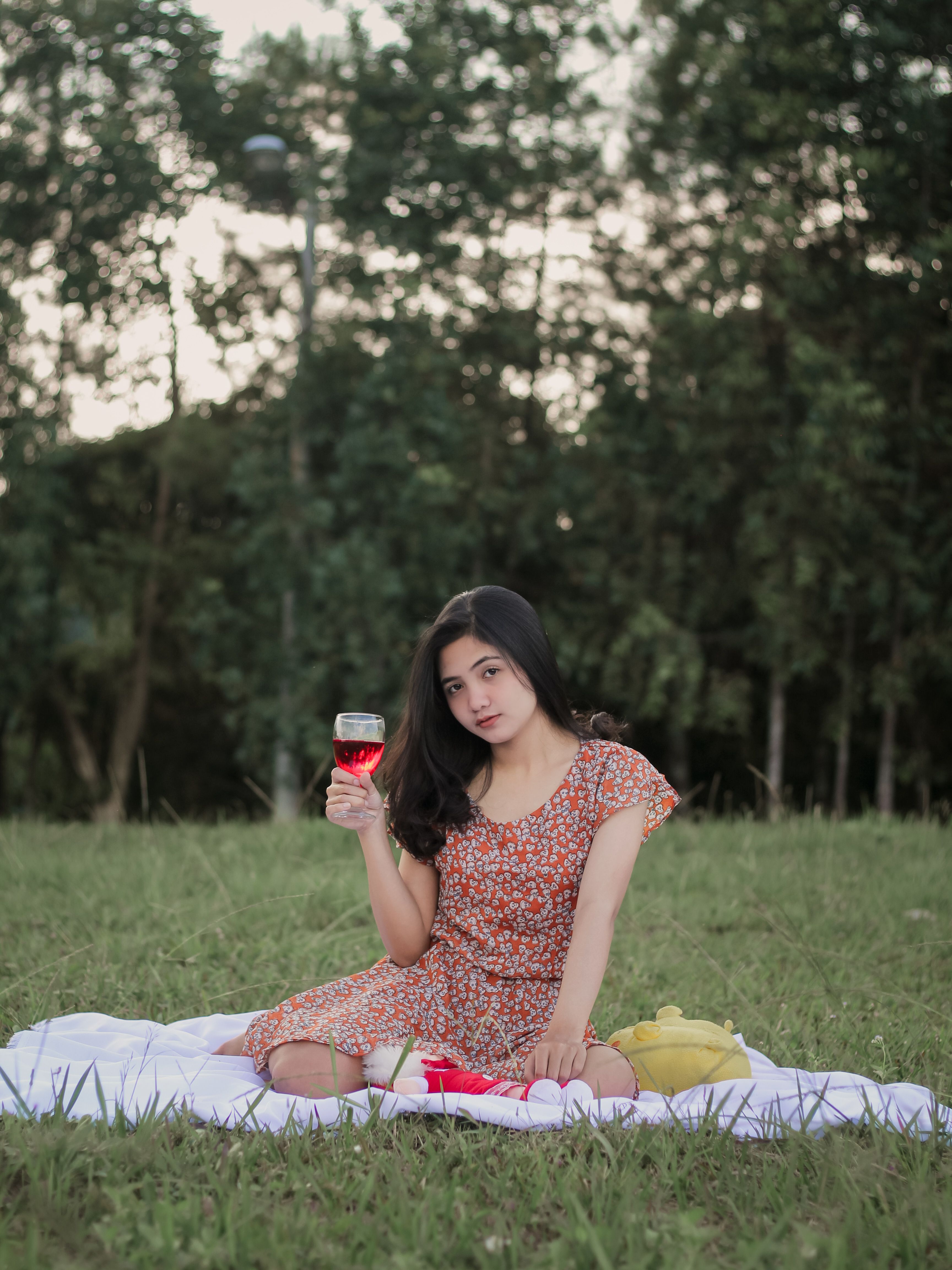 Photo of a Woman in a Floral Dress Holding a Glass of Wine · Free Stock ...
