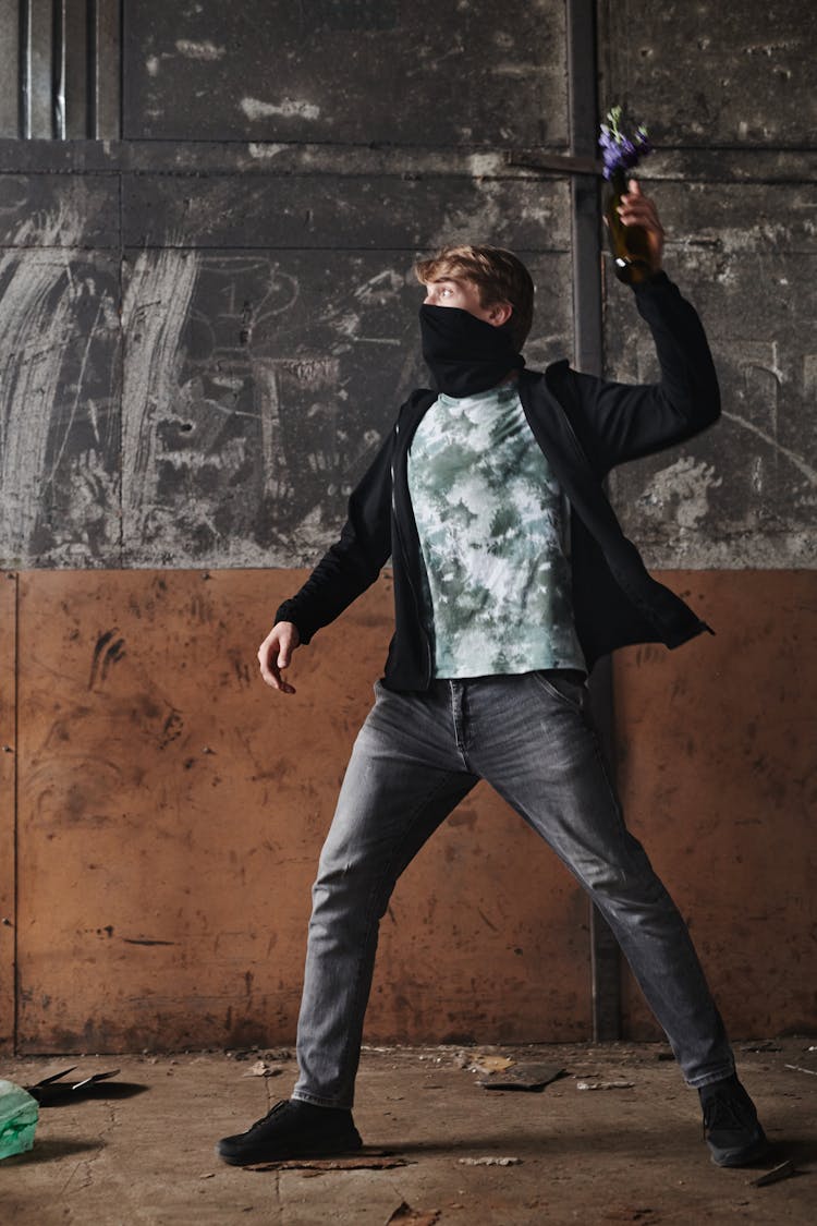 Man Throwing A Bottle With Flowers