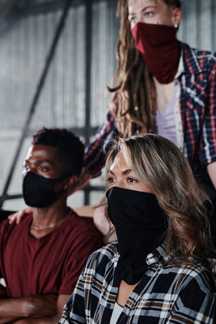 Group Of People Wearing Face Masks Sitting Inside Warehouse