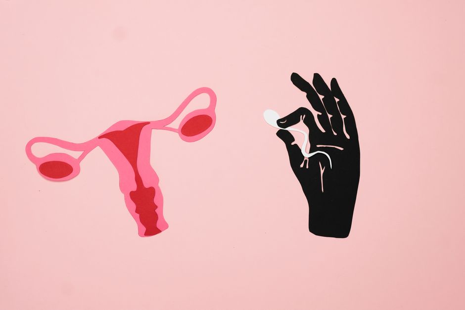 Creative abstract depiction of fertility using artistic symbolism on a pink background.