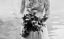Woman in Lace Long Sleeve Dress Holding Bouquet of Flowers