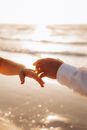Hands of a Couple Over a Body of Water