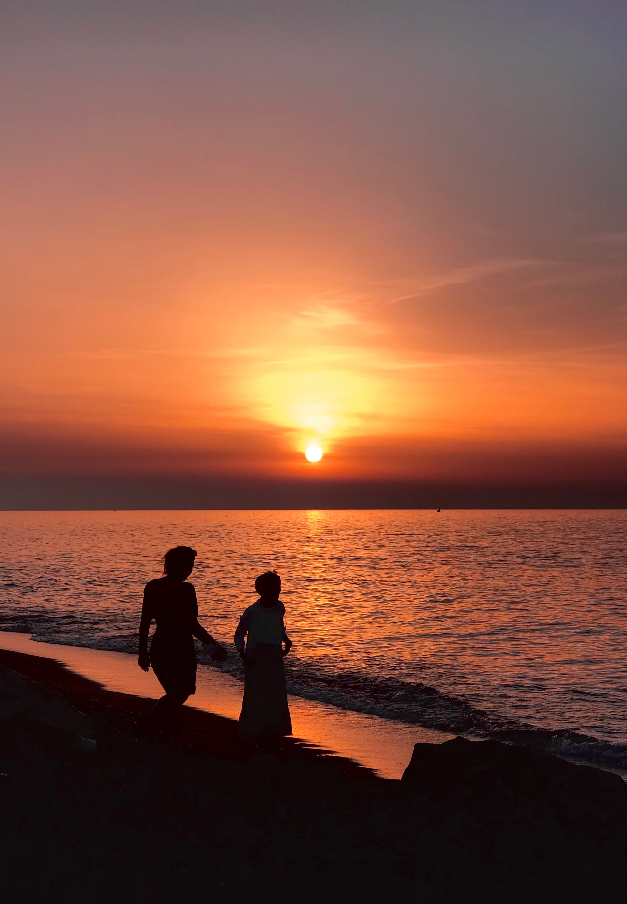 Silhouette of Women Walking on the Beach at Sunset · Free Stock Photo