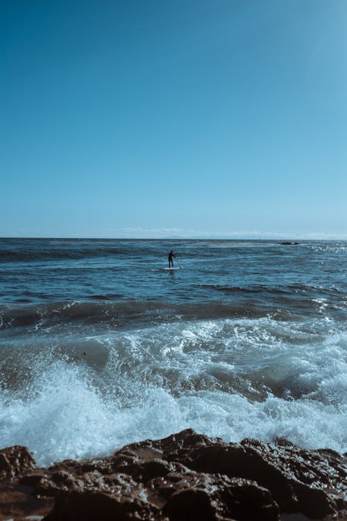 Man Surfing on Wavy Sea