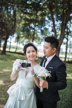 Charming couple at their wedding in a serene outdoor setting, capturing moments.