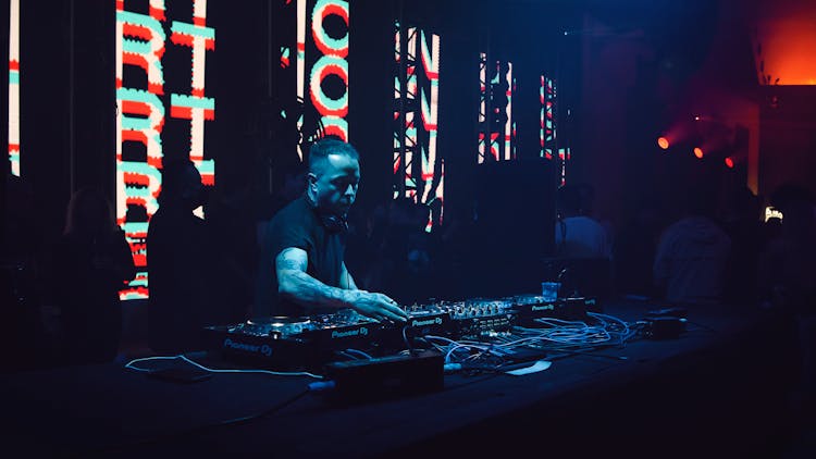 Man Playing Music Inside A Night Club