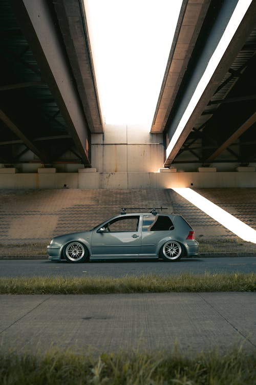 Silver Car Parked on the Road Under the Bridges