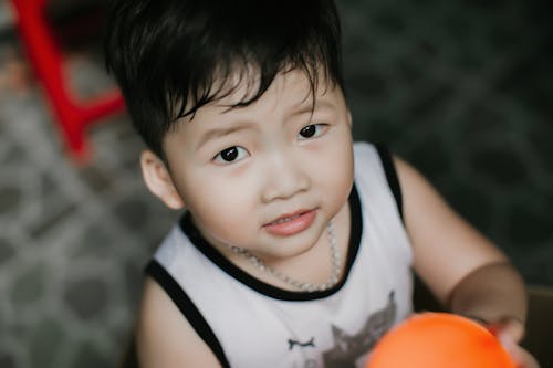 Free Close Up Photo of a Boy Wearing Tank Top Stock Photo