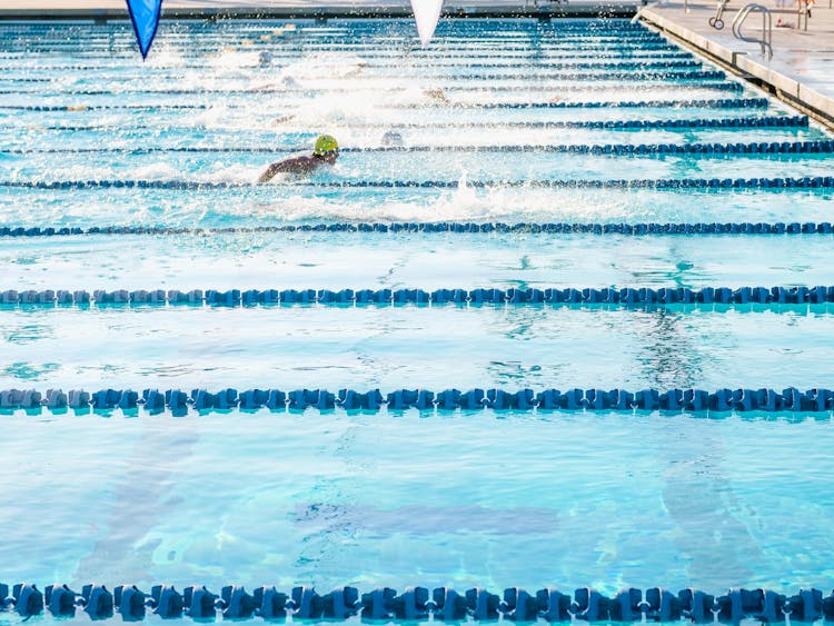 A Person Swimming In An Olympic Swimming Pool