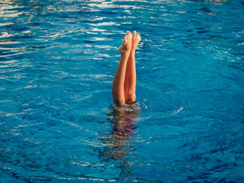 Bare Legs and Feet of Person Above Water