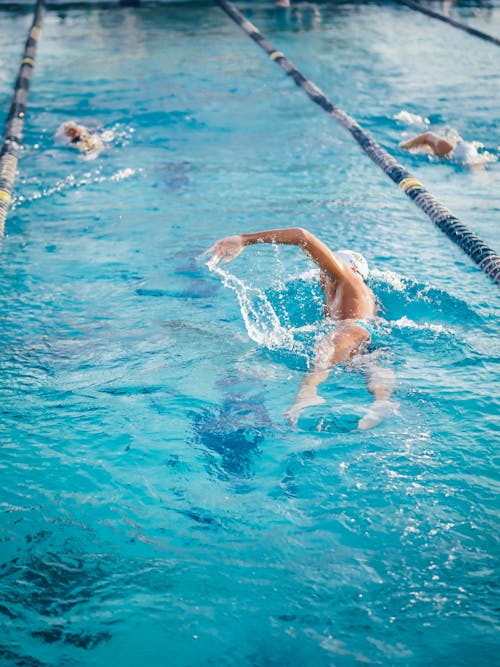 Free Man Swimming on an Indoor Swimming Pool Stock Photo