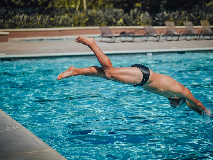 A Man Diving In The Pool