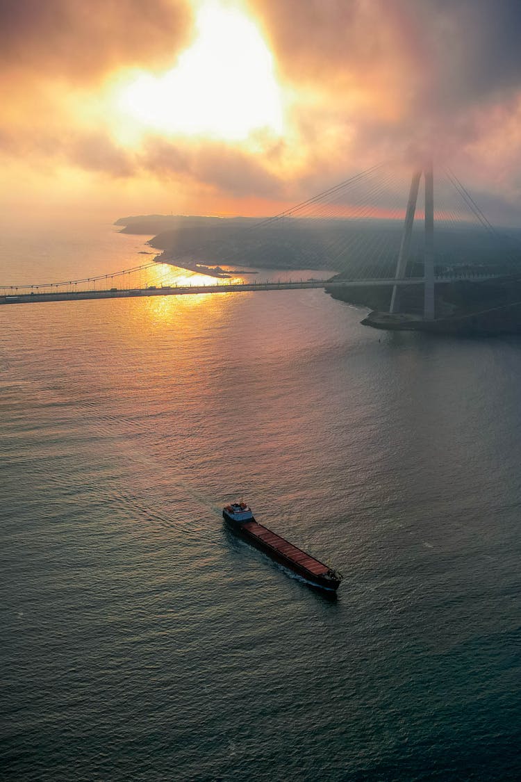 Aerial View Of A Ship Sailing Towards Yavuz Sultan Selim Bridge At Sunset 