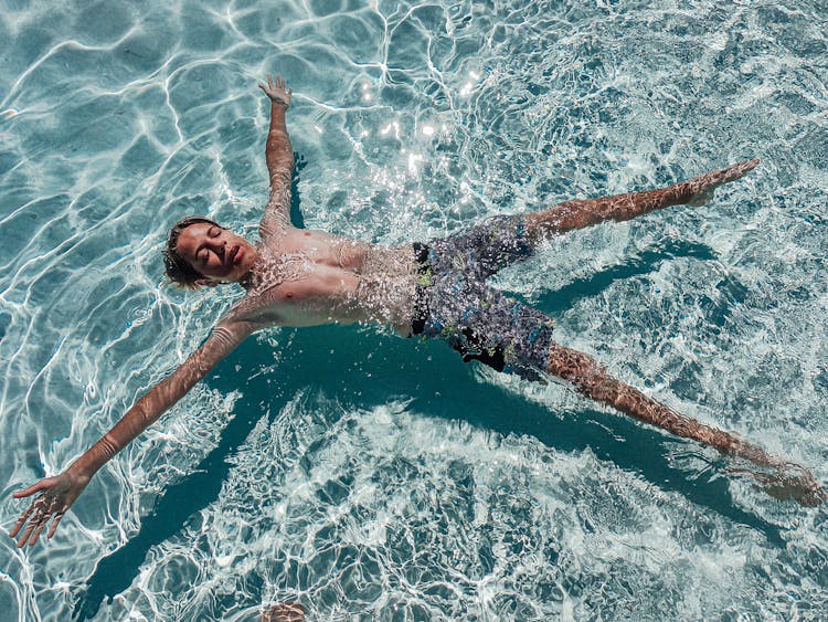 A Boy Floating On Water