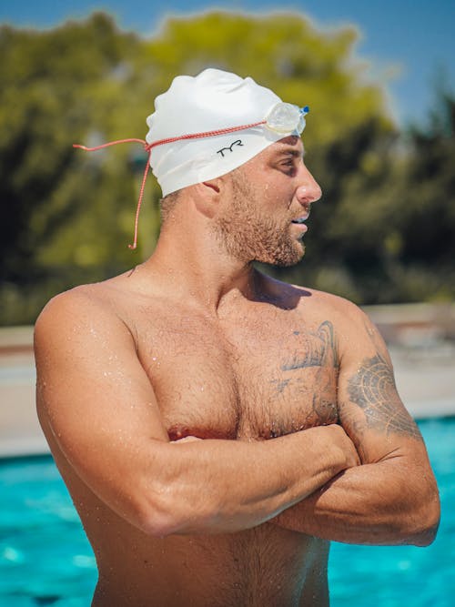A Shirtless Man With Swimming Cap and Goggles