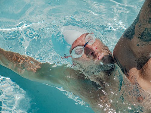 Free Man Swimming in Clear  Water Stock Photo