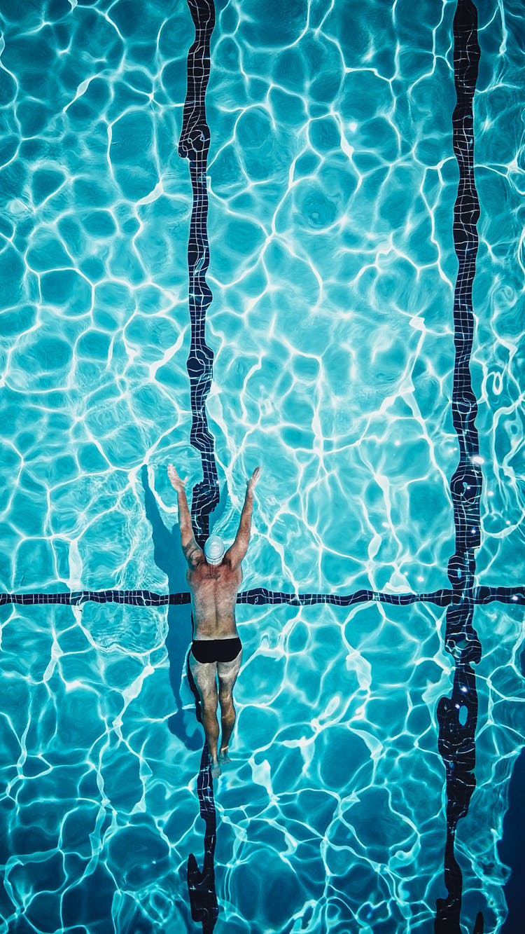 Drone Shot Of A Person Swimming In A Pool