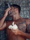 Man in Black and Red Tattoo Holding White Ceramic Mug
