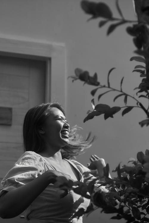 Grayscale Photo of Woman Laughing