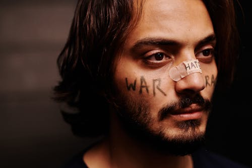 Close-Up Shot of a Man with Band Aid on His Nose