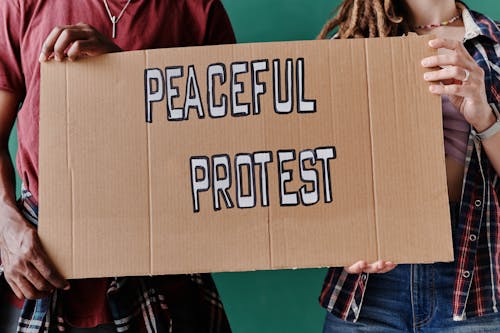 Two People Holding a Banner