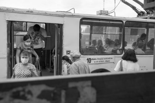 Free People wearing masks exiting a tram in Yekaterinburg, Russia amid pandemic precautions. Stock Photo