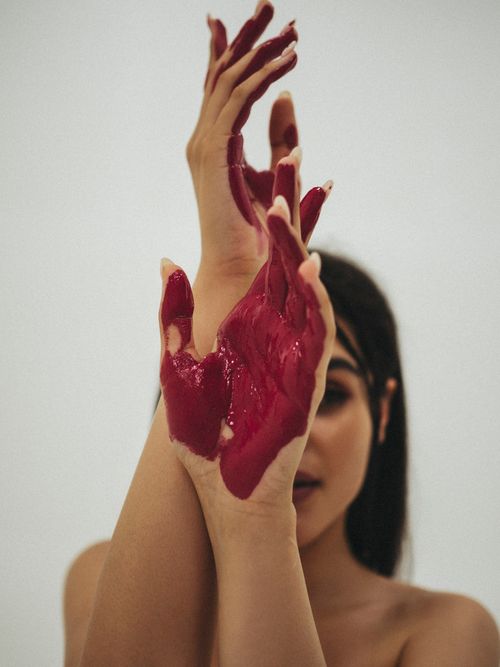 Free Close-up of a woman showcasing painted hands in a creative pose. Stock Photo