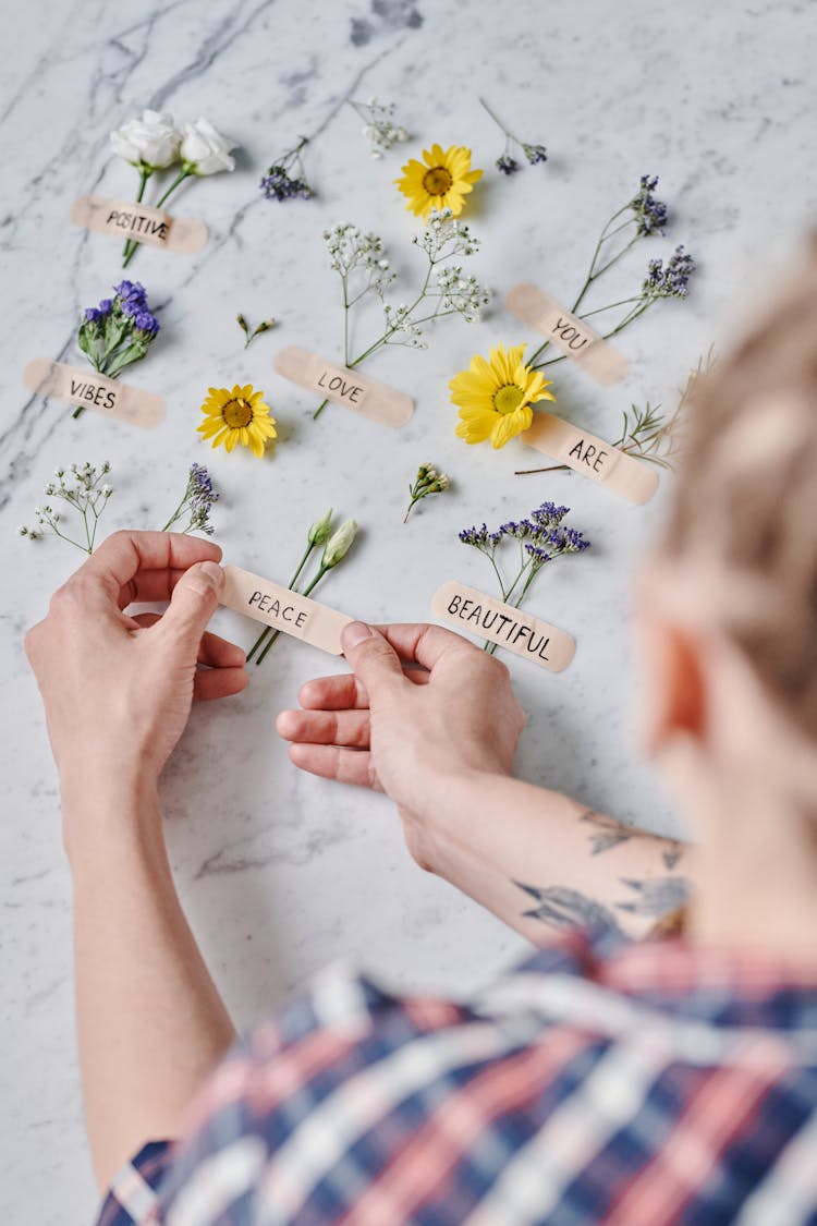 Person Labelling The Flowers